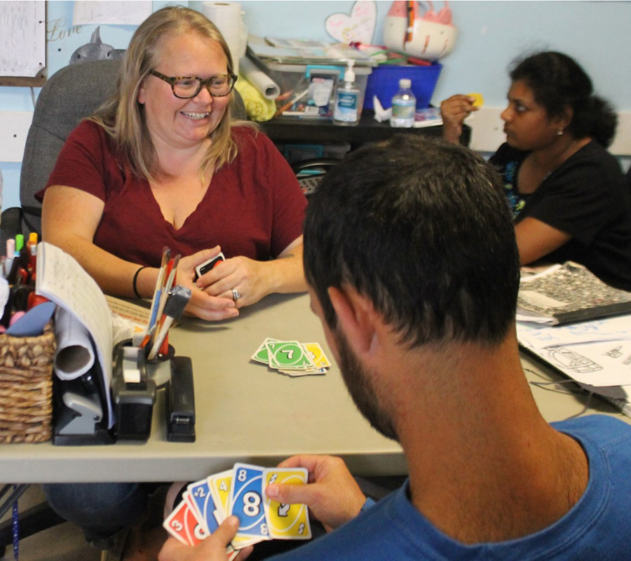 Site Based Habilitation Program Members Playing UNO