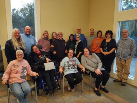 Photo shows everyone who was at Alice's party gathered together. They are facing the camera.