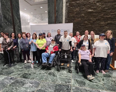A group photo shows Living Resources team members and supported individuals at advocacy day.