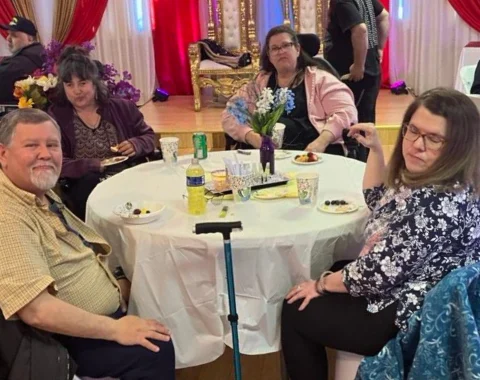 Four people are seated around the table.