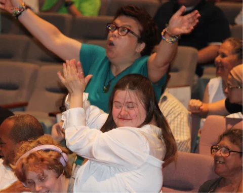 Audience members are applauding and cheering at the awards ceremony.