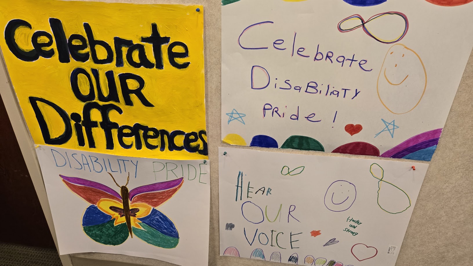 20260721_132627 4 disability pride posters hang on a wall.